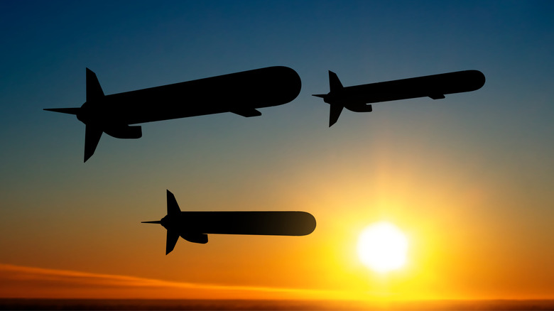 Silhouettes of Tomahawk cruise missiles against the sunset