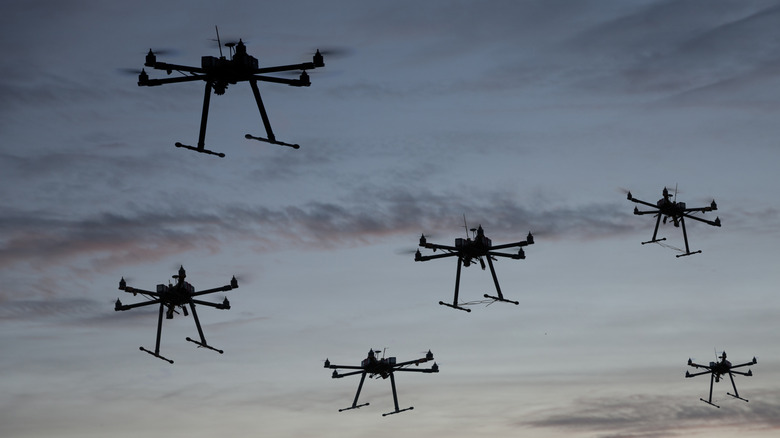 A swarm of drones flying in the air