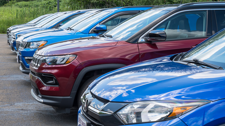 A line of vehicles for sale at a Ford dealership