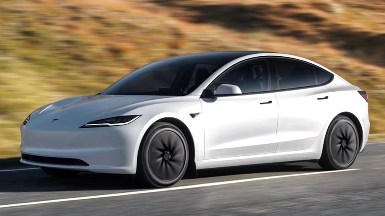 White Tesla Model 3 driving on a rural road