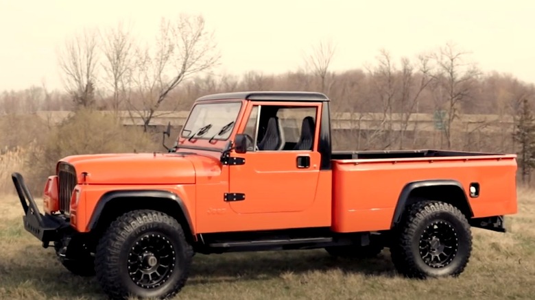 Orange Jeep CJ-10 truck parked