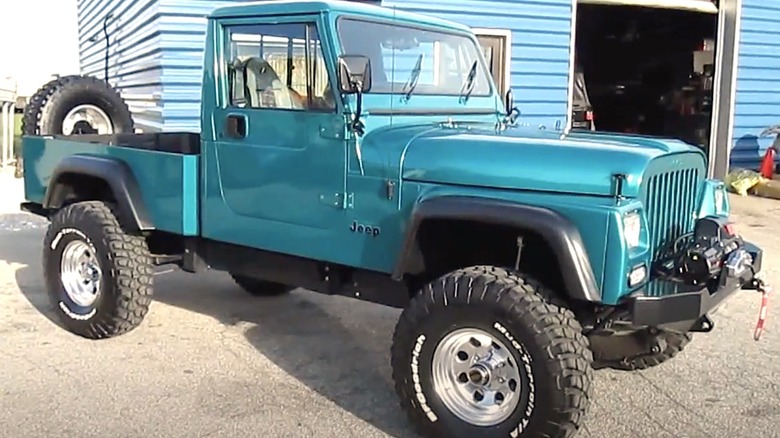 Blue Jeep CJ-10 truck parked