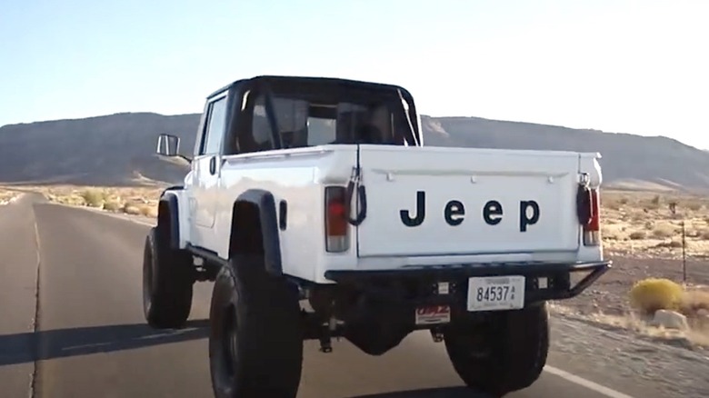 White Jeep CJ-10 driving