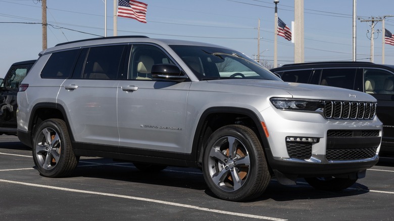 Silver Jeep Grand Cherokee Limited parked dealership