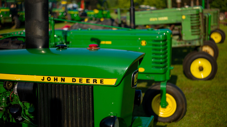 John Deere tractors lined up at an event