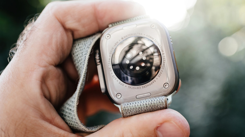 Person showing Apple Watch biosensor.