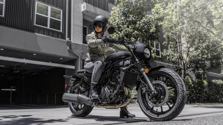 Low angle shot of a woman on the 2026 Kawasaki Eliminator 500 SE leaving a drive way.