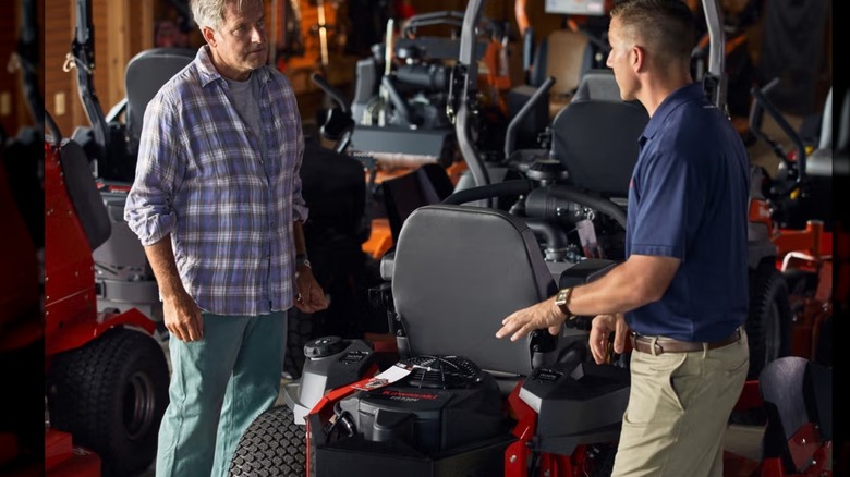 Two people discussing a Kawasaki engine