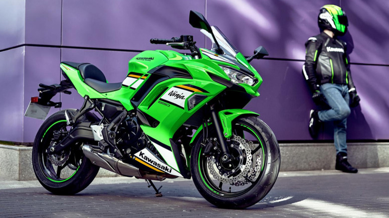 Parked Kawasaki Ninja 650 KRT edition on the street with rider in background