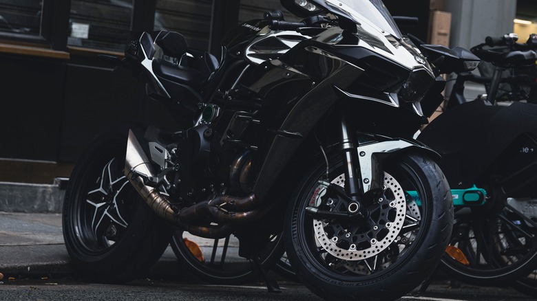 A black Kawasaki Ninja H2R parked on a the street in the evening