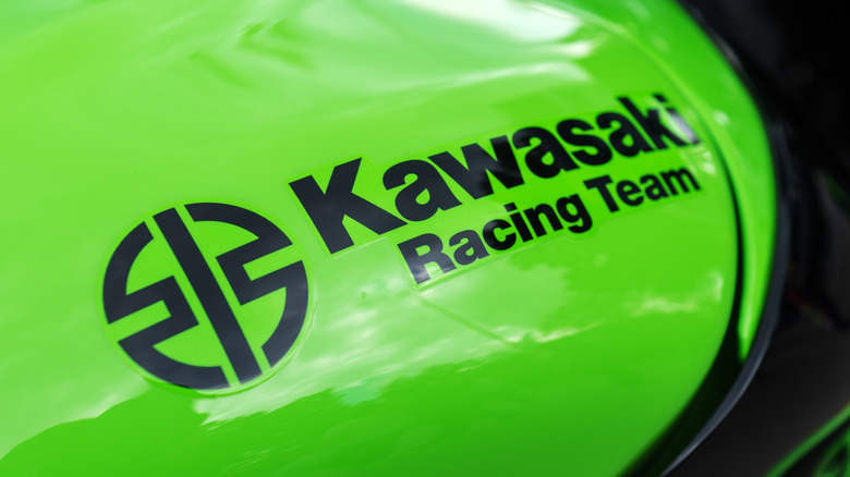 The Kawasaki Racing Team logo on a green bike.