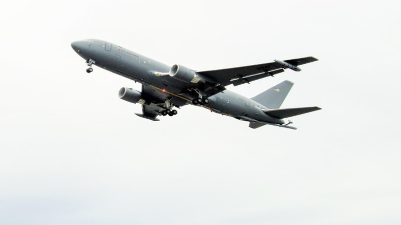 The KC-46A Pegasus against a cloudy sky in the background.
