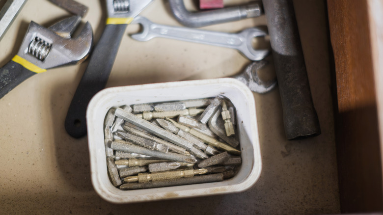 Screwheads in drawer with wrenches
