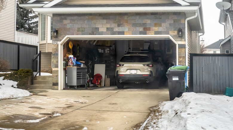 Exterior of a garage in the winter as seen from the inside, its door open