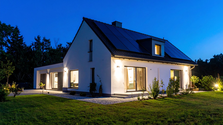 A home at night with several exterior lights on