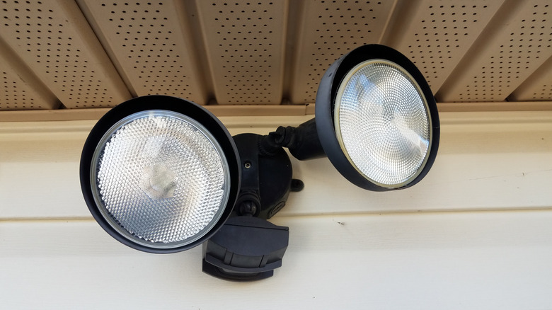 A closeup of a motion-sensing security light during the day