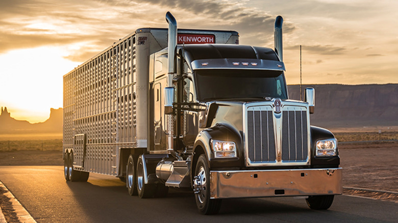 Black Kenworth W990 on the road at sunset