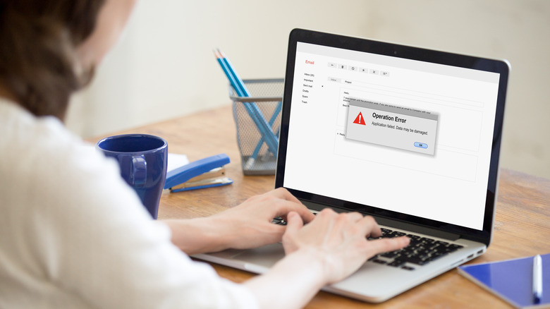 Person staring at laptop screen that is showing an error