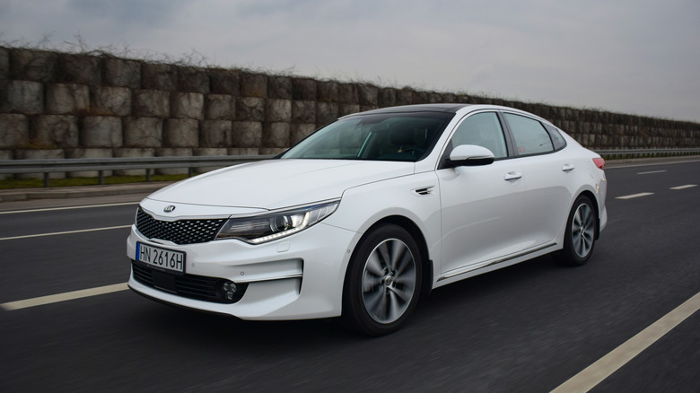 Kia Optima driving down highway