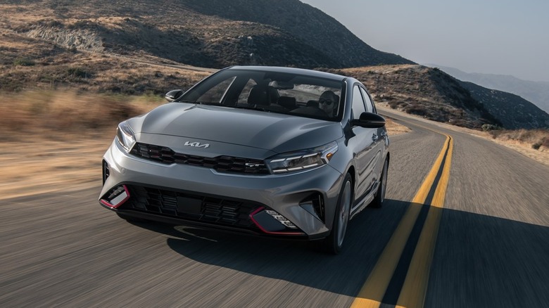 Kia Forte driving down desert road