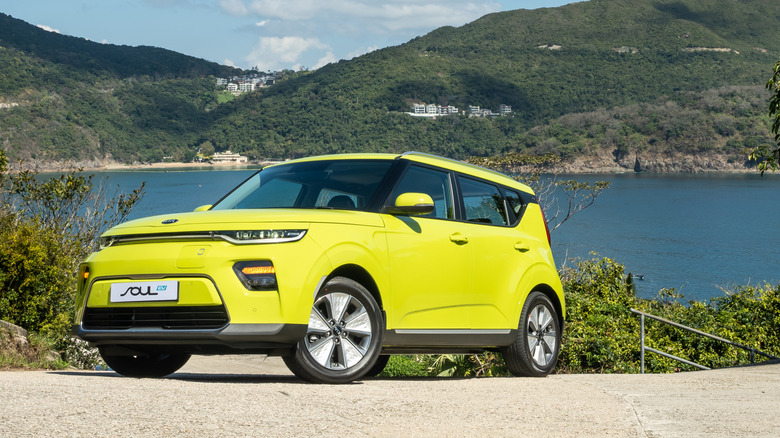 yellow kia soul near water