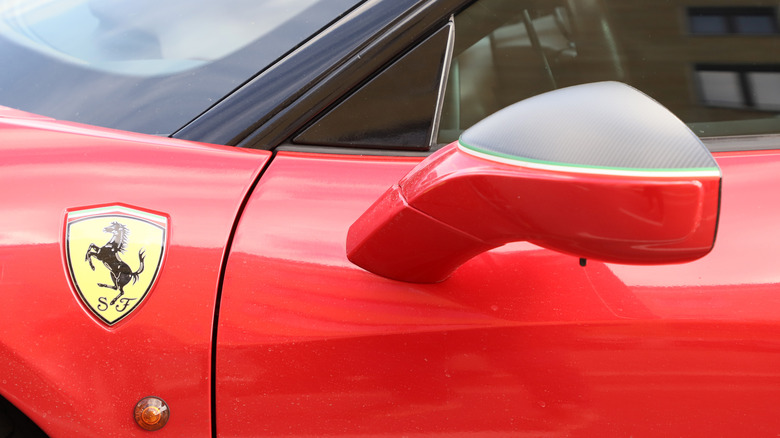 Close-up of Ferrari 488 GTB showring left-side mirror and Ferrari logo
