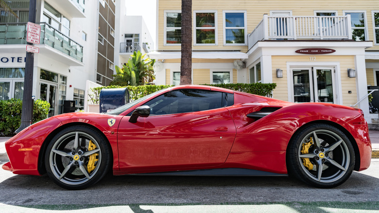 Side view of a Ferrari 488 GTB parked on a sidewalk.