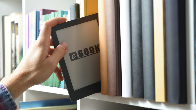 Person taking ebook from library shelf