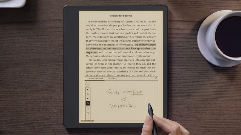 Person writing on Kindle Scribe with stylus
