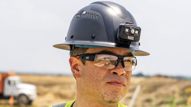 Man wearing Klein Carbon Fiber Hard Hat with Headlamp at jo