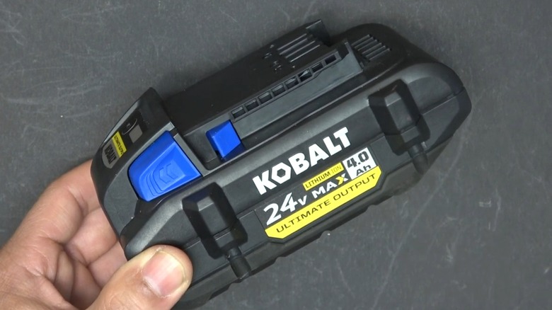 A person holding a Kobalt battery.