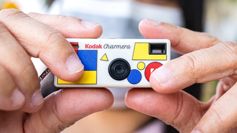a person holding the Kodak Charmera and taking photos with it