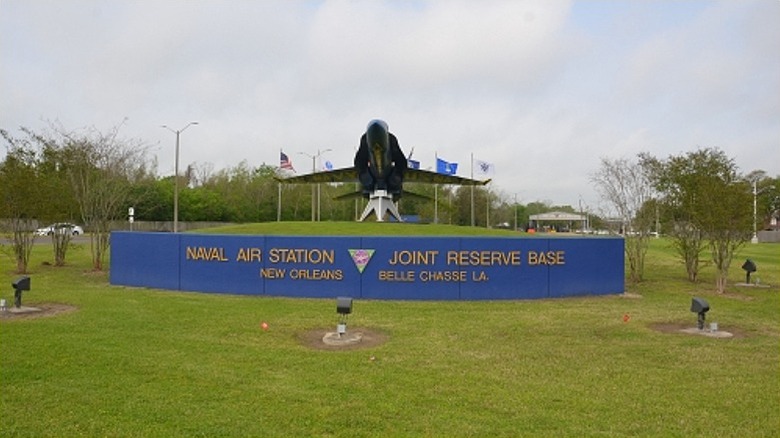 Naval Air Station Joint Reserve Base sign in front of an airplane monument