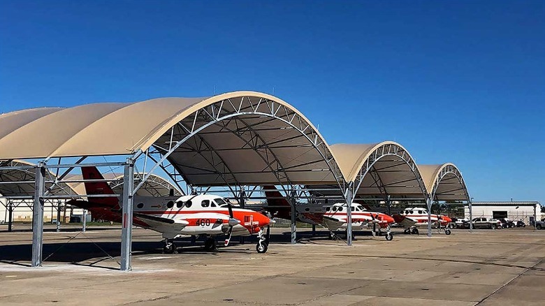 Aircrafts parked under a shade
