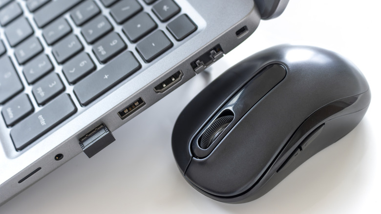 Wireless mouse and USB receiver plugged into laptop