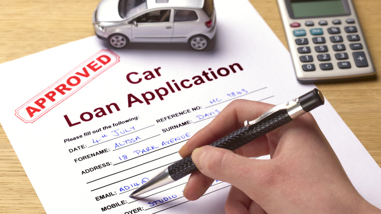 Signing a car loan application