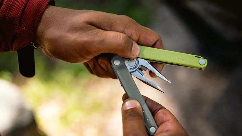 Person opening a Leatherman Bond multi-tool.