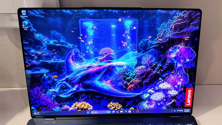 The Lenovo Yoga Slim 9i 14 Gen 10 display showing vibrant blue in an undersea image.
