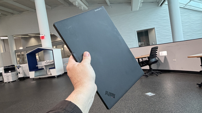 Man holding a Lenovo ThinkPad X13 Gen 6