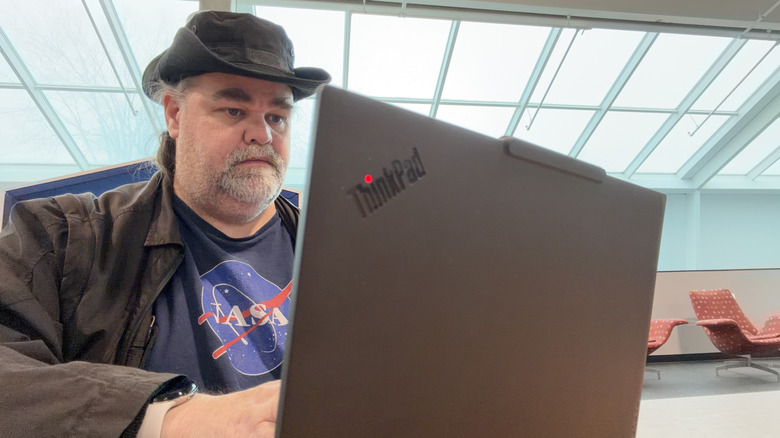 Man sitting at a Lenovo ThinkPad X13 Gen 6