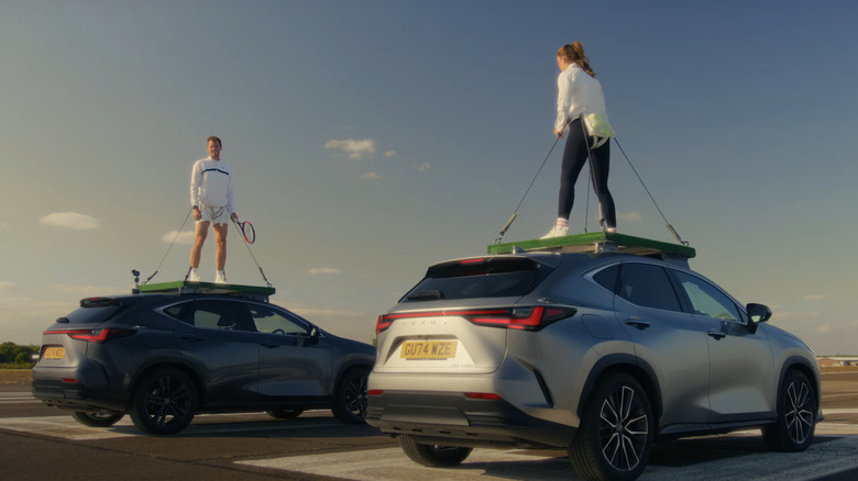 Laura Robinson and Jamie Murray, two tennis players, strapped on top of two Lexus NS Crossover cars in the Served At Speed World Record attempt.