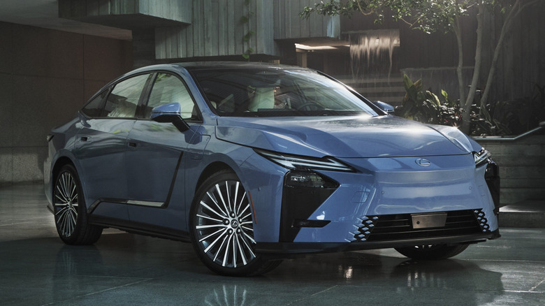 Front right view of blue Lexus ES parked in front of house