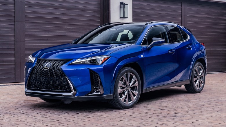Blue 2026 Lexus UX parked in front of a house.