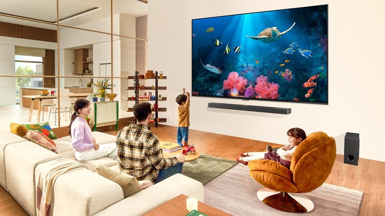 LG QNED TV being watched by a young family