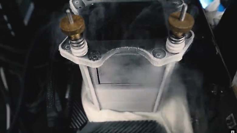 Metal heat sink on a CPU covered in frozen condensation from a frozen nitrogen cooling system.