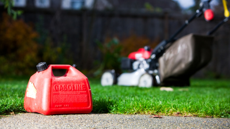 Gas can with lawn mower in background
