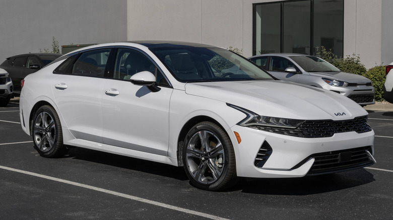 White 2023 Kia K5 parked in a dealership lot