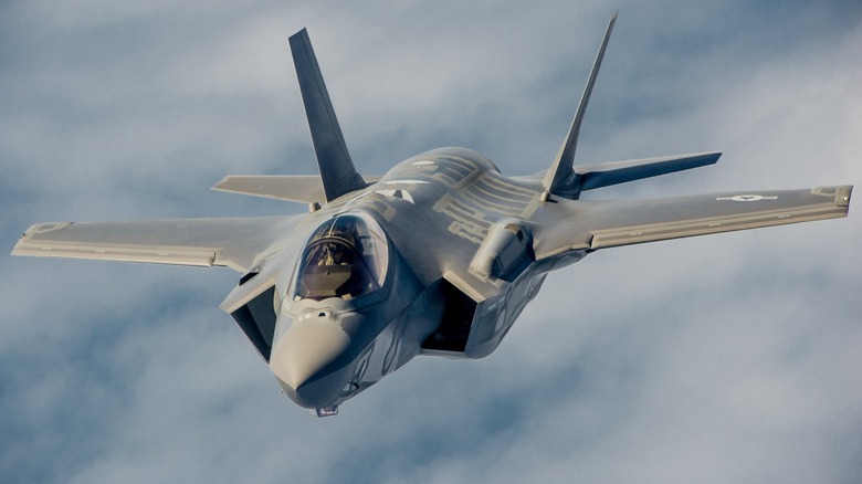 An F-35A Lightning II flying over cloudy skies