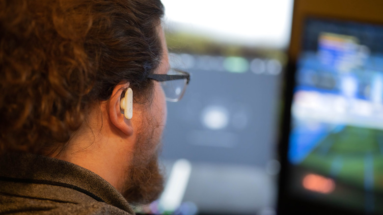 Person wearing Logitech G Fits earbuds