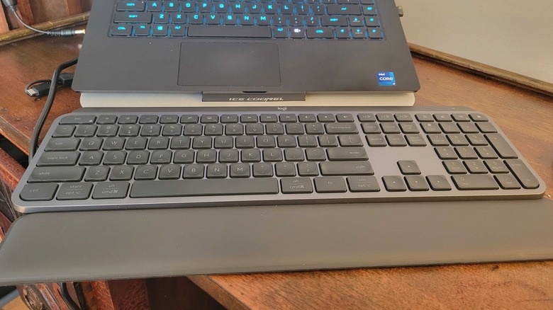 MX Keys S on a small desk with a laptop